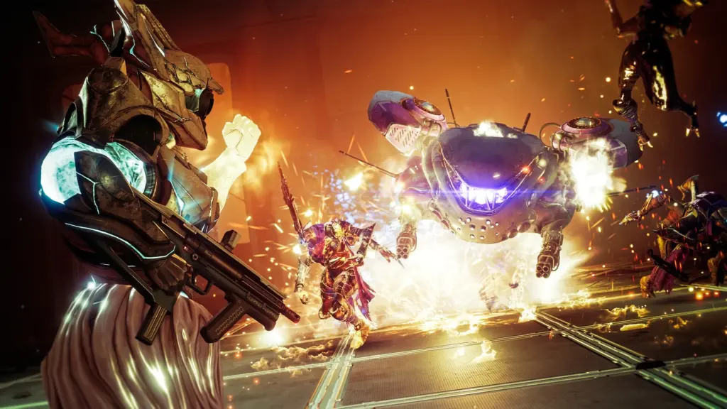 Zrzut ekranu z gry Destiny 2 przedstawiający walkę postaci z dużym, mechanicznym przeciwnikiem w otoczeniu wybuchów.